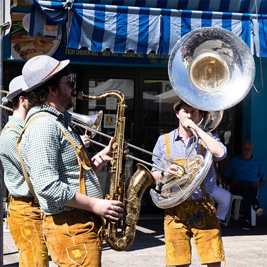 people playing a sousaphone on the street