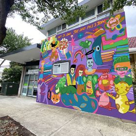 Colourful mural of faces and shapes on a building
