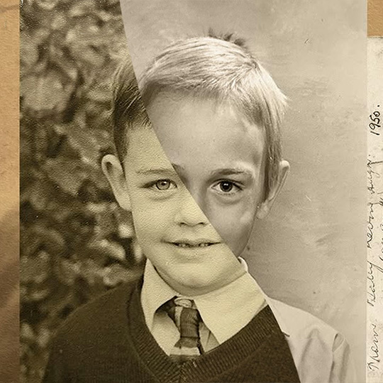 A paper collage of two boys' faces, split in a roughly diagonal line through the middle to form one single face.