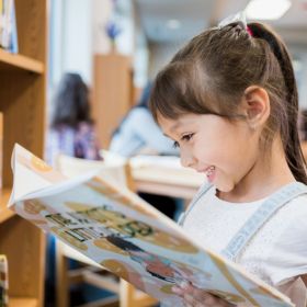 Girl reading a book in the library