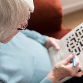 Senior woman completing crossword