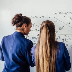 Two students solving a maths equation