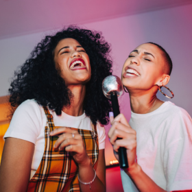 Two women singing karaoke