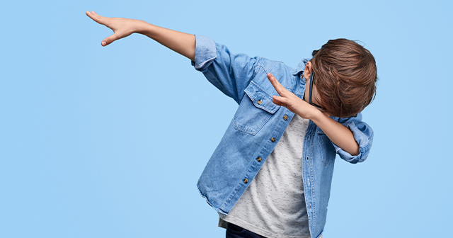 Young boy performing the dab