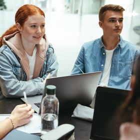 Young teen students in a group conversation