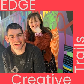 Studio ARTES EDGE Creative Trails promotional image, two people smile and one leans on the others back resting their fist on their chin