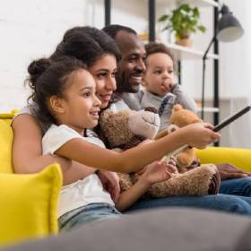 Family watching TV on the couch