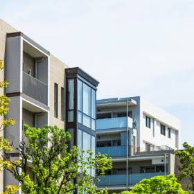 The tops of modern apartment buildings with some sky