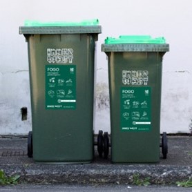 Two green lidded fogo wheelie bins