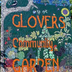 Ceramic tile saying Glovers community garden with flowers and plants