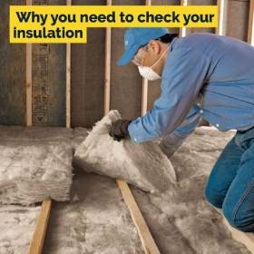 Man putting insulation in roof