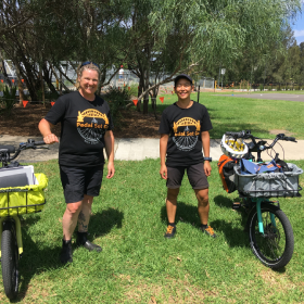 two people standing near a bike