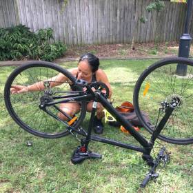 Woman checking her bike wheel