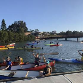 multiple people in canoes on a river