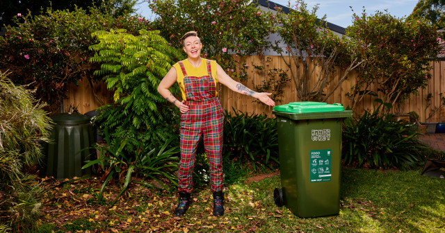 lady in back yard with new FOGO green bin