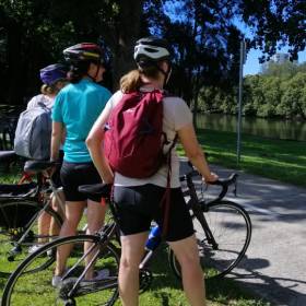 Women standing with bicycles overlooking the cooks river