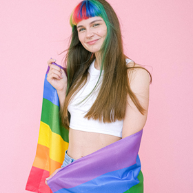 Woman with rainbow flag wrapped around her