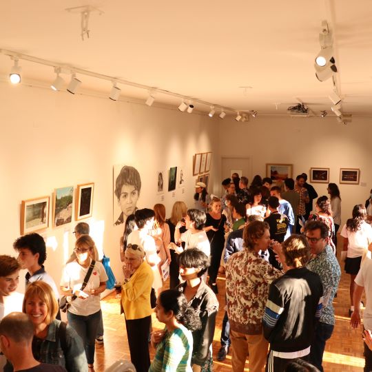 A busy opening event in an art gallery.