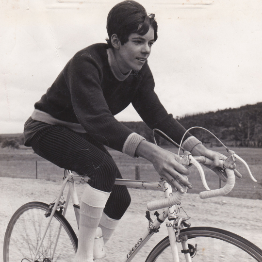 Black and white photo of a woman cycling