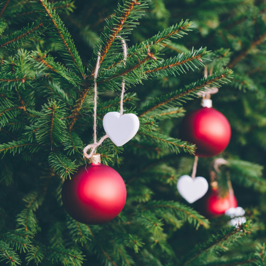 Baubles hanging from a Christmas tree.