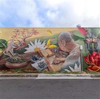 A mural of an elderly Vietnamese man doing ink painting in his study