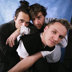 Three men festing on each other's shoulders