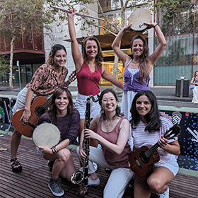 a group of women with instruments pose