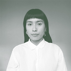 A black and white photo of a woman with black hair and a white shirt