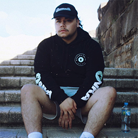 A man in sportswear sits on the stairs