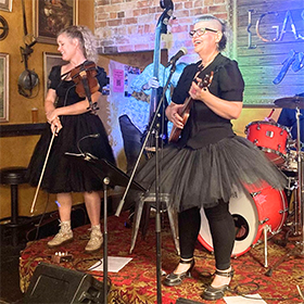 a woman in a tutu playing on stage