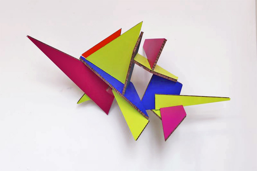 Colourful artwork, cardboard and paint in geometric triangle shapes. 