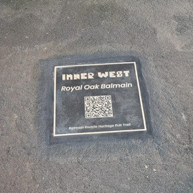 brass footpath plaque with the Inner West logo and the words 'Royal Oak Balmain' with a QR code underneath