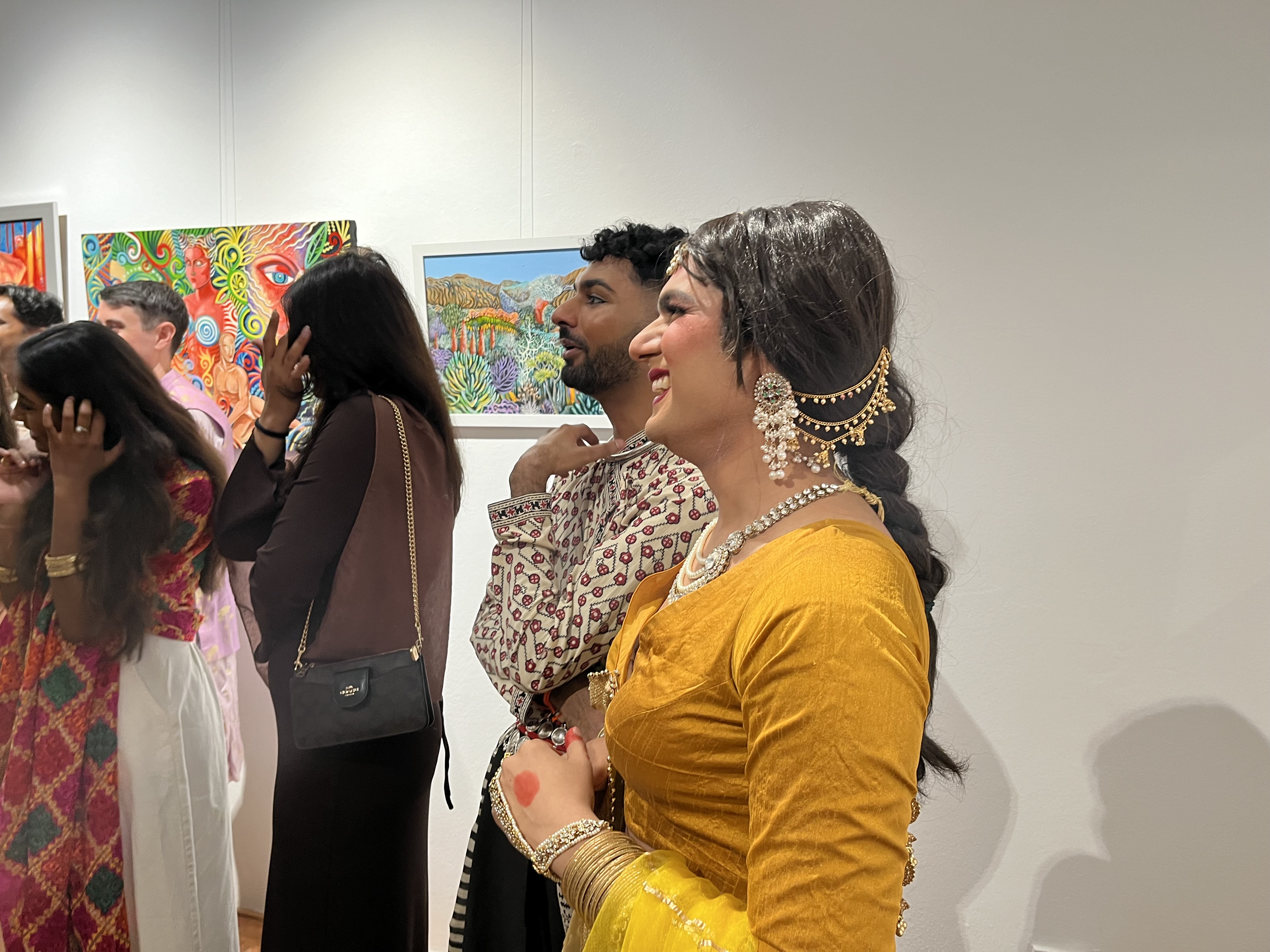 Photo of performer @Paye_rae in yellow sari smiling humbly