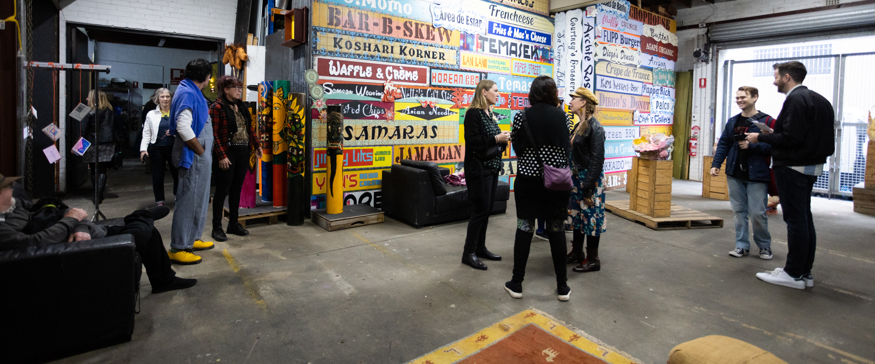 Photo of a group of people in a studio type warehouse